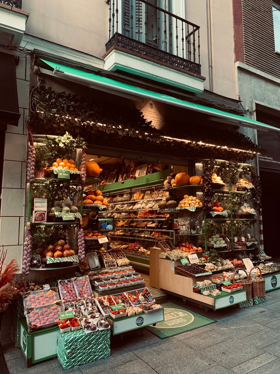 Free Vibrant street market stand with fresh, local fruits and vegetables on display. Stock Photo